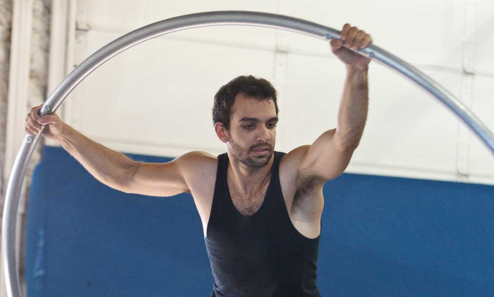 man training on cyr wheel