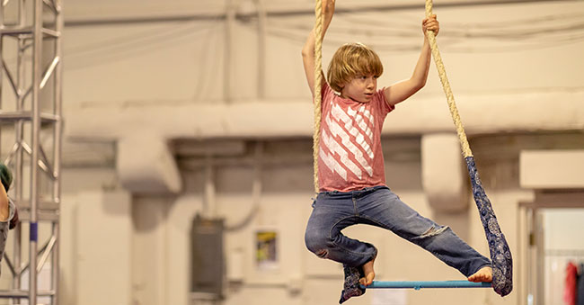 young boy on trapeze