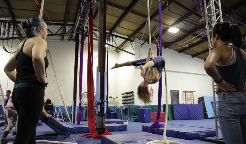 two students on trapeze